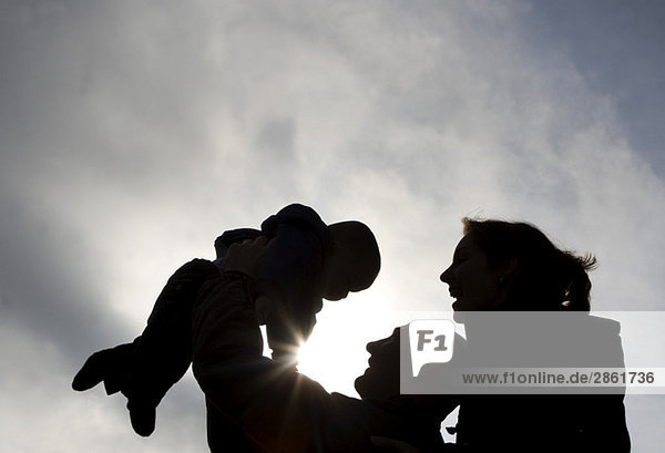 Silhouette of Family  Father lifting child (1-2)  close-up