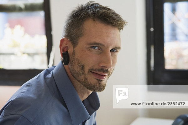 Business man in office wearing headset  portrait