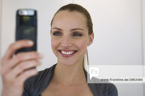 Business woman holding mobile phone  portrait