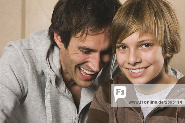 Germany  Father and son (14-15)  smiling  portrait