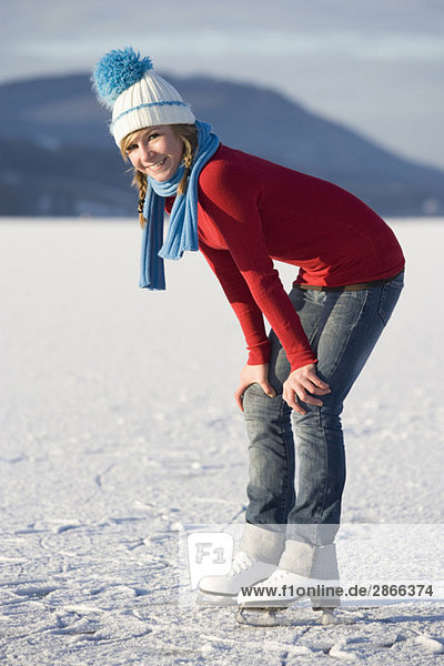 Austria  Salzkammergut  Lake Irrsee  Female teenager (14-15 on skates  smiling