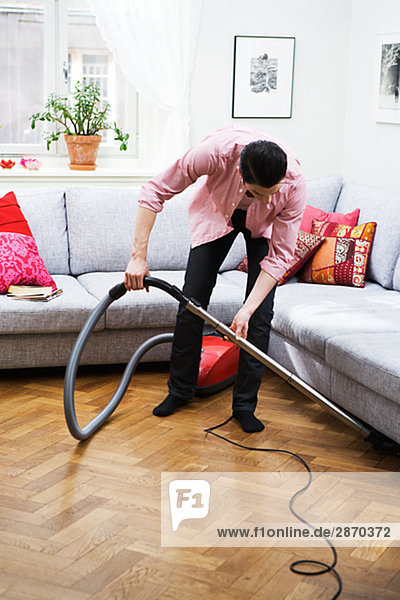 A man vacuuming Sweden.