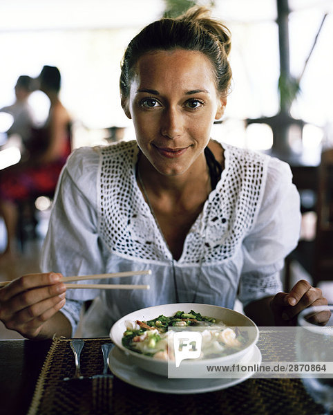 A Scandinavian woman having lunch Thailand.