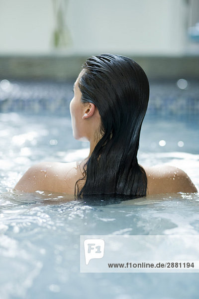 Rear view of a woman in a swimming pool