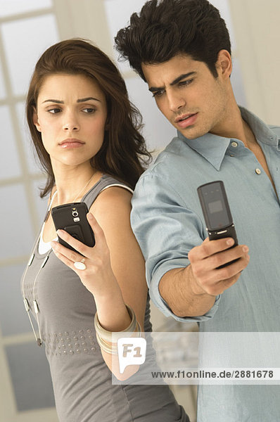 Couple holding mobile phones