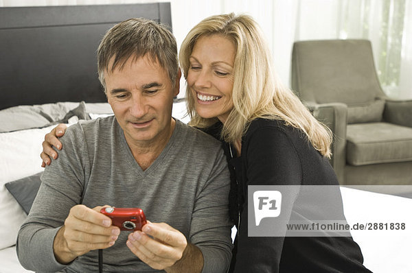 Couple looking at a digital camera