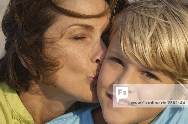 Woman kissing her grandson