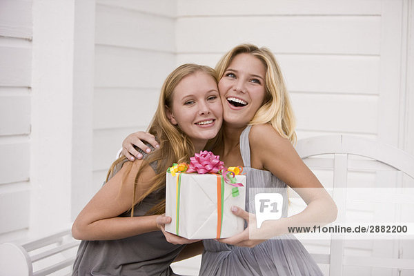 Woman giving a present to her friend