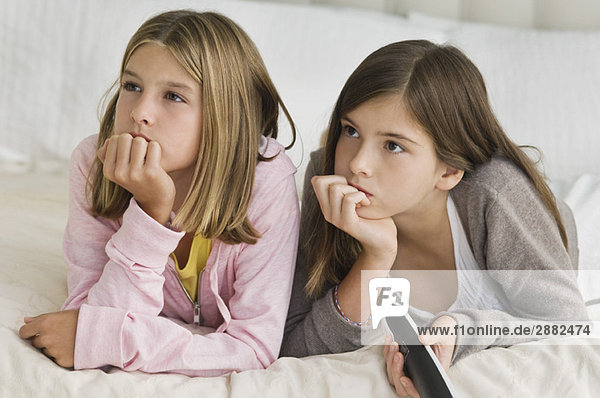 Two girls watching television