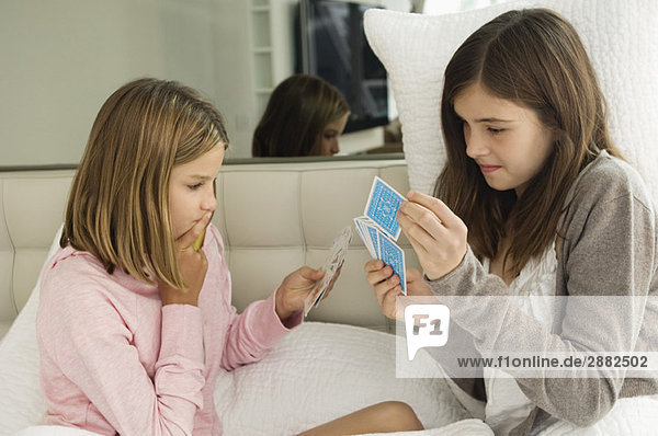 Two girls playing cards