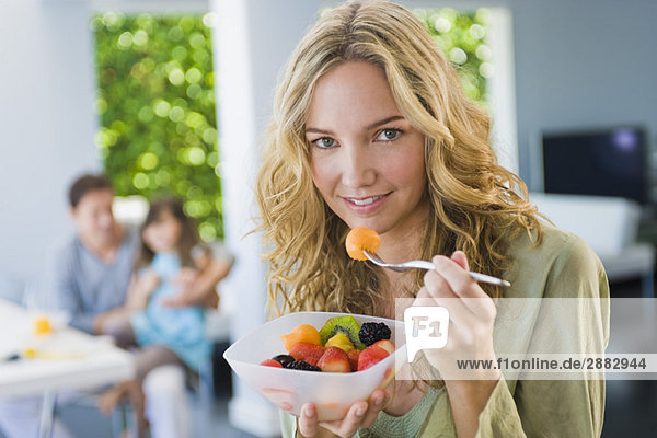 Woman eating fruit salad
