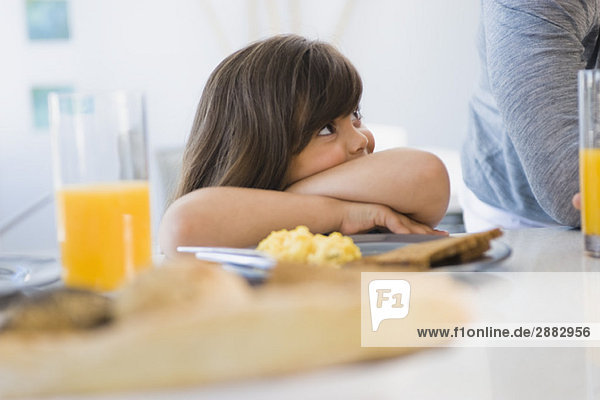 Girl with her father at the breakfast table