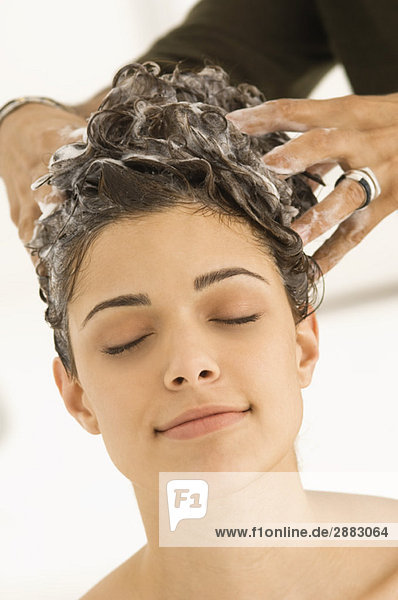 Woman having hair washed by a hairdresser