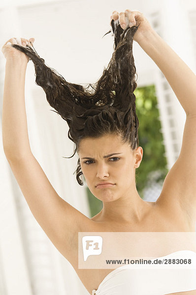 Portrait of a woman shampooing her hair