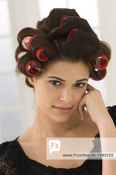 Portrait of a woman with hair curlers in her hair