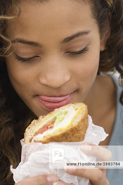Close-up of a girl eating a sandwich