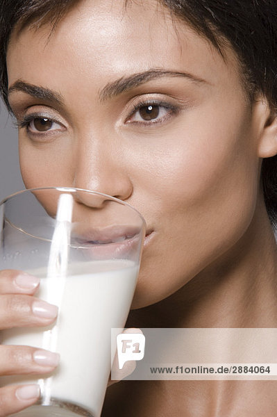 Close-up of a woman drinking milk from a glass