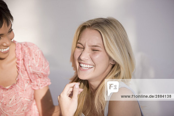 Close-up of two women laughing