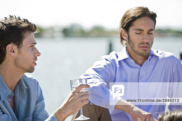 Man enjoying drink with his friend