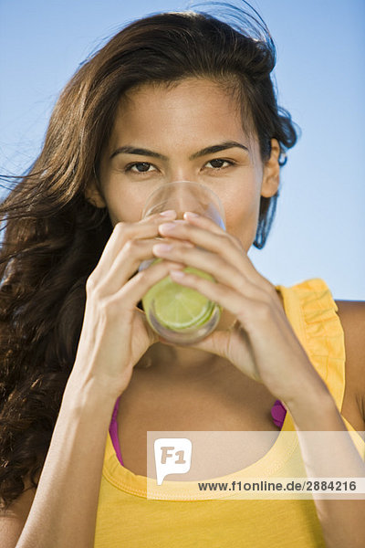 Portrait of a woman drinking lemonade
