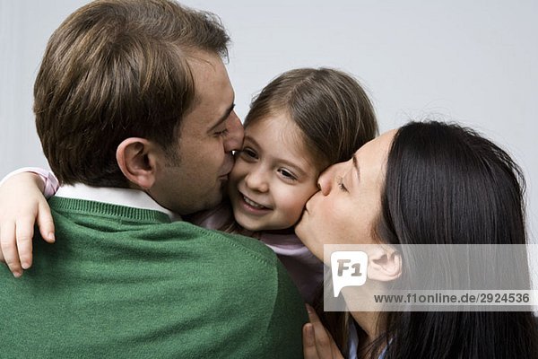 A daughter embracing her parents