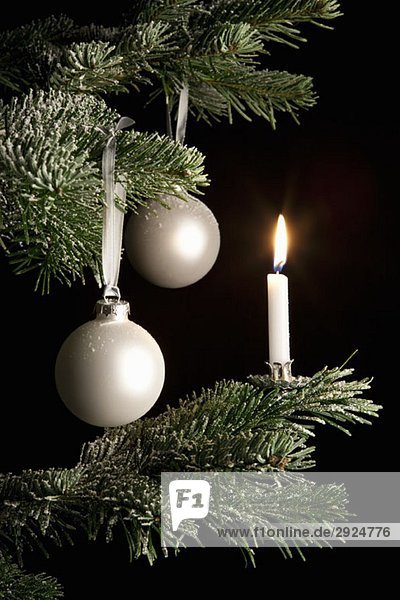 Decoration and a candle on a Christmas Tree