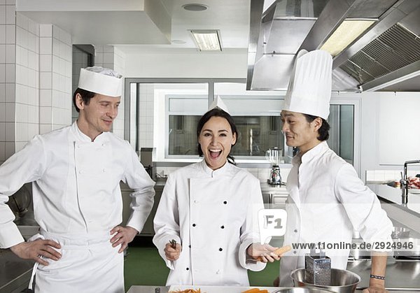 Two chefs teasing another chef