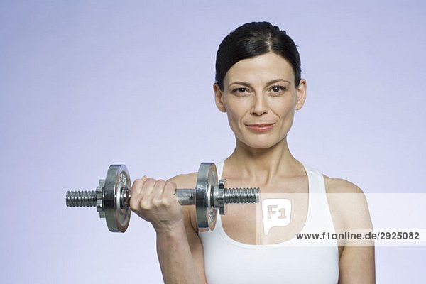 A woman holding a dumbbell