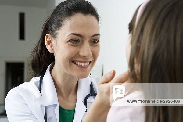 A doctor examining a girl's glands