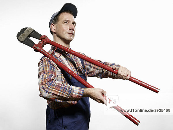 A man holding bolt cutters over his shoulder