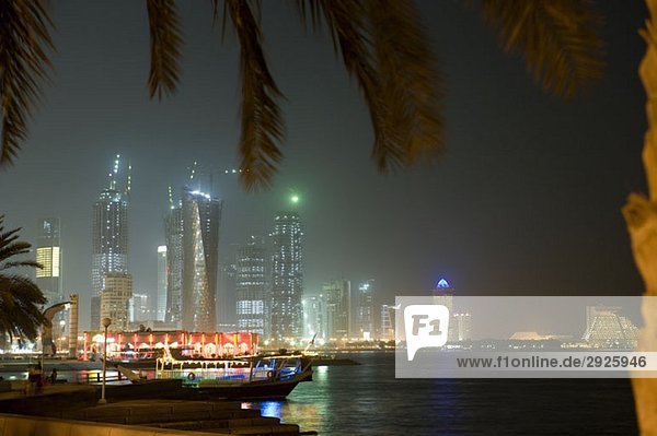 Harbor and cityscape at night  Doha  Qatar