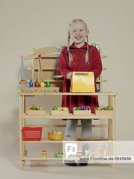 Portrait of a girl in a toy grocery store