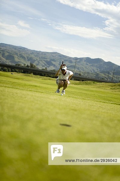 A golfer lining up a shot  Palm Springs  California  USA
