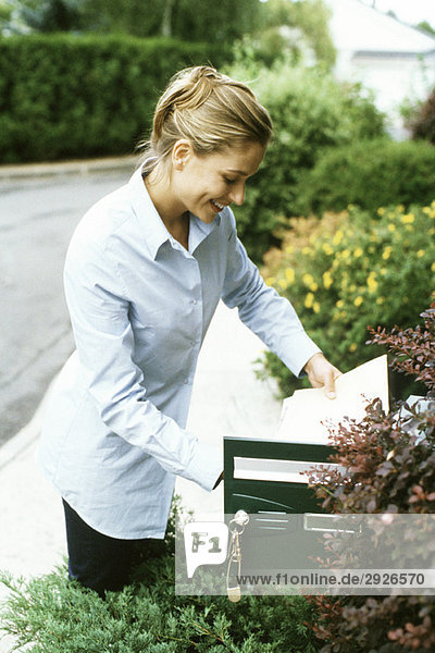 Frau beim Postchecken  lächelnd