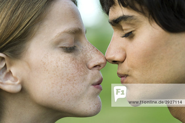Young couple touching noses  puckering  profile