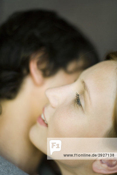 Young couple embracing  cheek to cheek  close-up