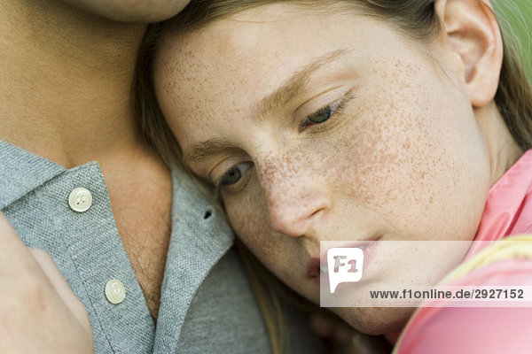 Young woman resting head on man's chest  close-up