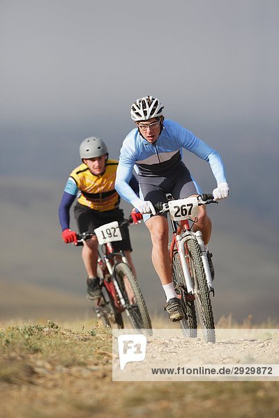 Two mountain bikers racing