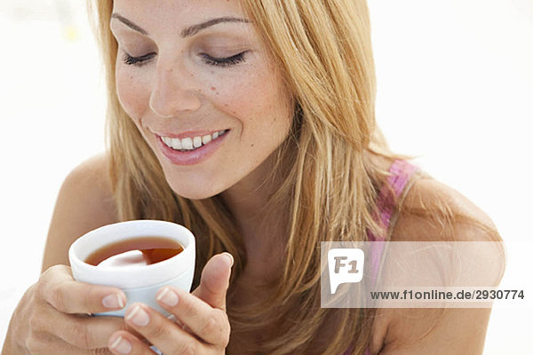 young woman enjoying cup of tea