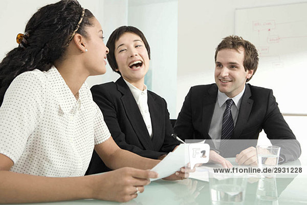 Three colleagues laughing