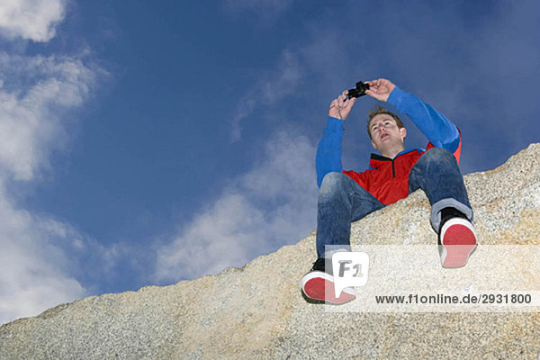 man taking picture on mountain top