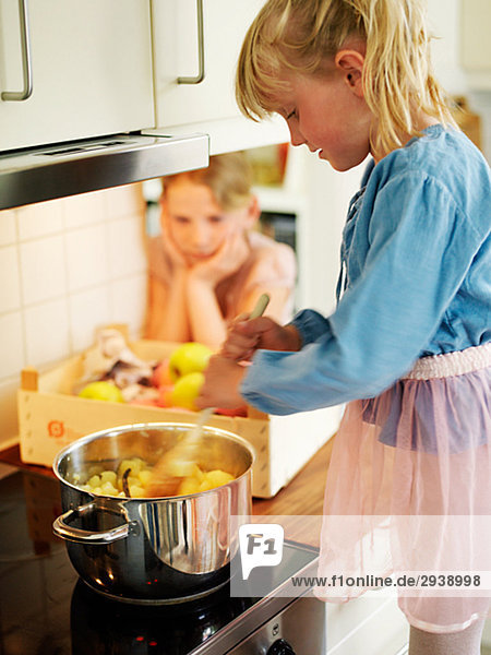 Two children making apple sauce Sweden.
