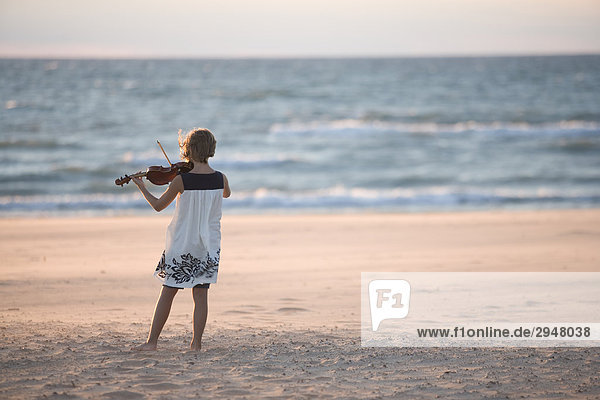 Girl playing the violin on a beach Warrens Dunes State Park Michigan