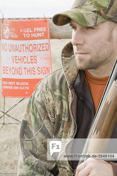 Man with 12 gauge shotgun near Davenport  Washington.