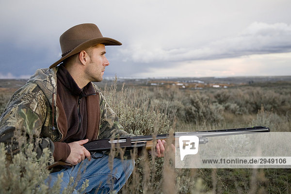 Man with Remington 12-gauge shotgun  Davenport  Washington