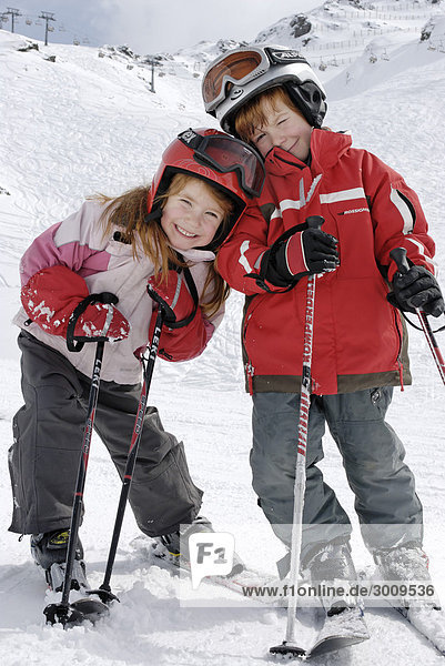 Two children skiing in the mountains