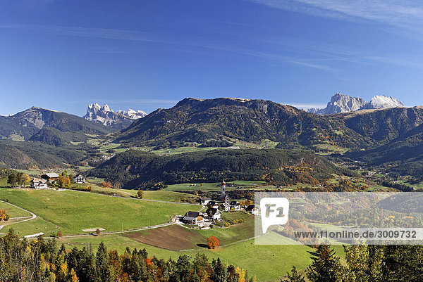 Der Ort Mittelberg und links Sass Rigais (3025m) und rechts Langkofel und Plattkofel  Rittener Berg  Südtirol  Italien