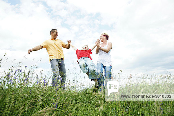 Family playing on a meadow  low angle view