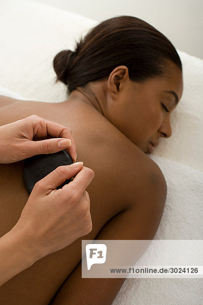 Woman having stone massage