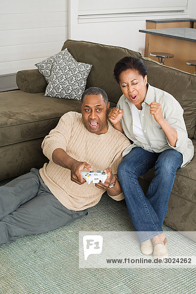 Mature couple playing video game